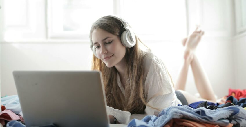 woman in white shirt using silver macbook